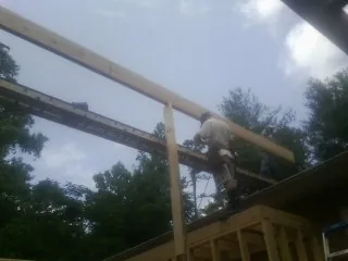 Carpenter setting a ridge beam over a new addition frame — Ice Dam Removal by Roofing Brothers in Washington Court House
