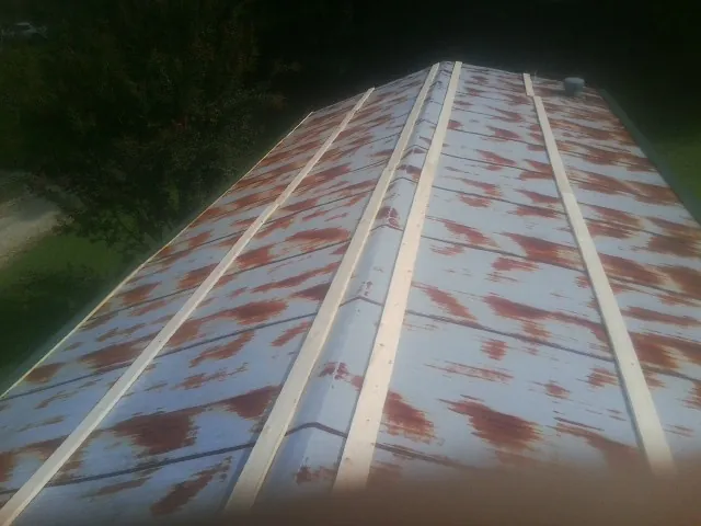 Rusted metal roof panels with new wood purlins before replacement — Storm Damage Roof Repair in Washington Court House by Roofing Brothers