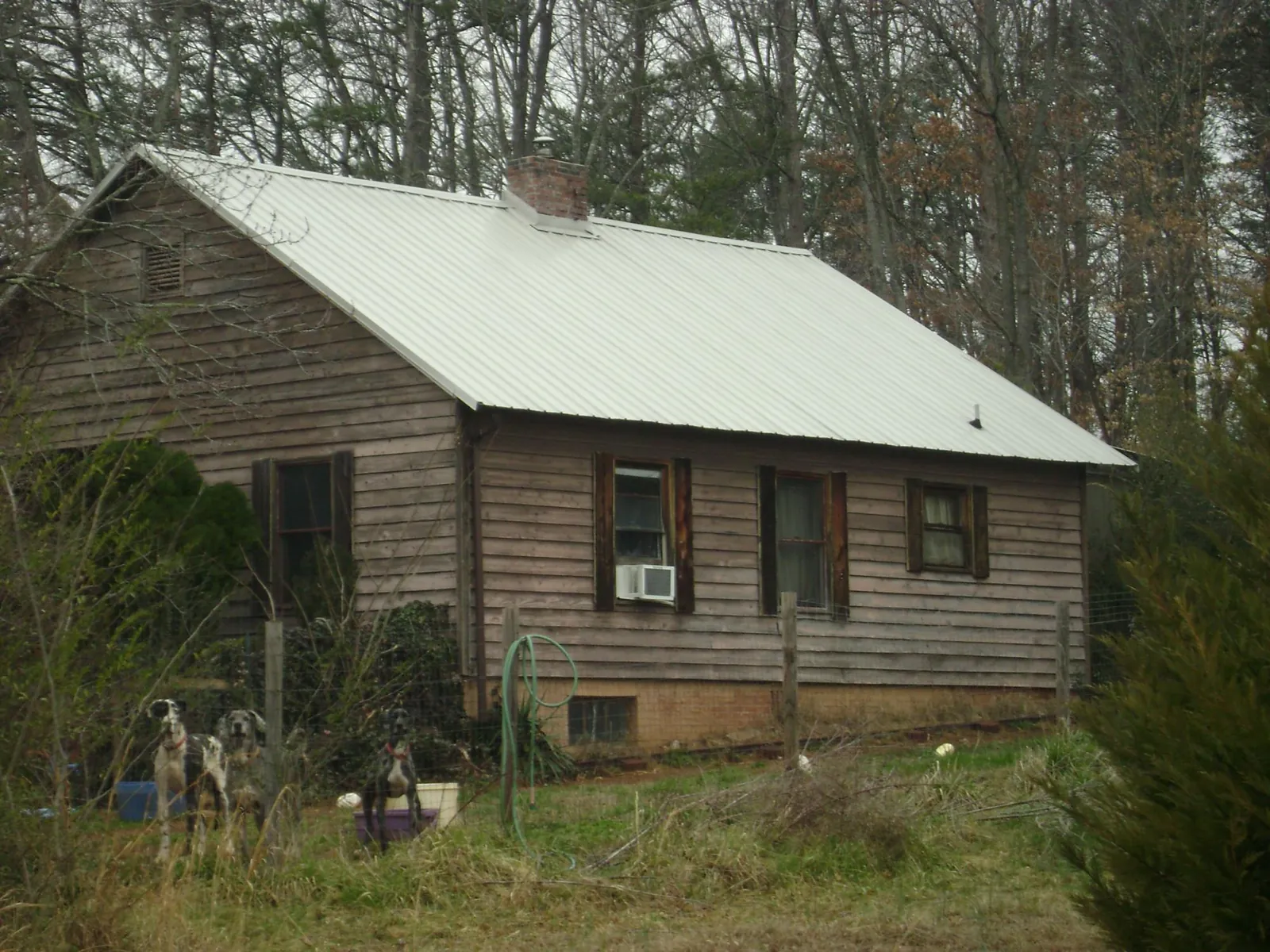 White metal roof on an old wood sided farmhouse, from a Asphalt Shingle Roof Repair job in Washington Court House